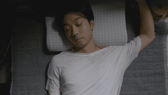 Man sleeping peacefully on a pillow