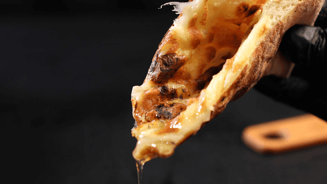 Cheese pizza dipped in sauce