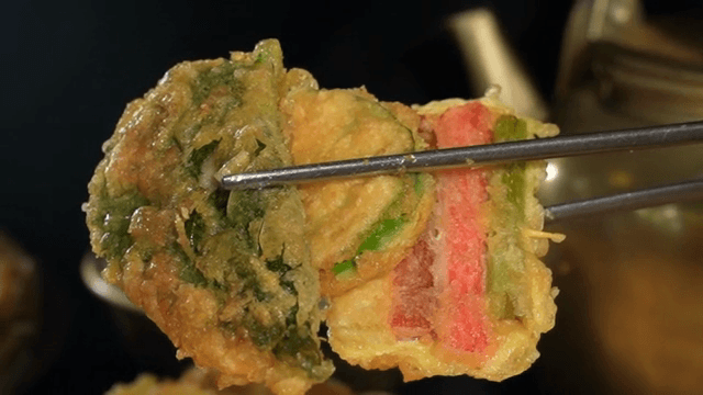 Korean pancakes held with chopsticks