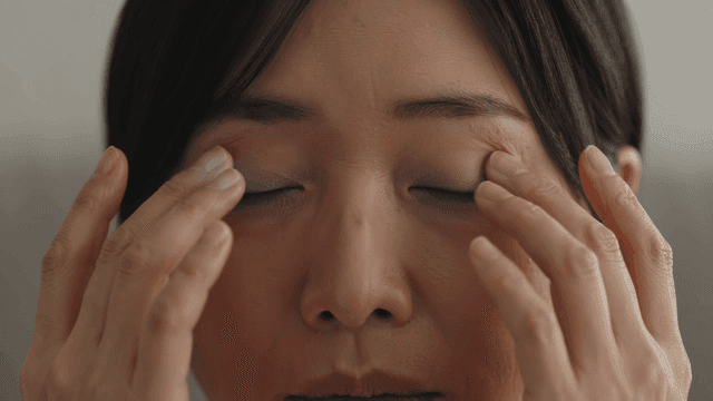 Woman gently massaging her sore eye
