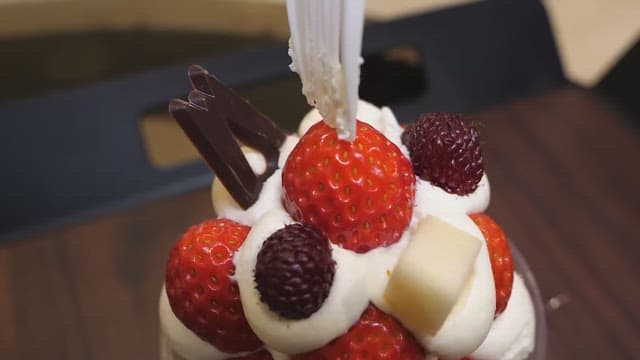 Decadent strawberry dessert being eaten slowly with a fork