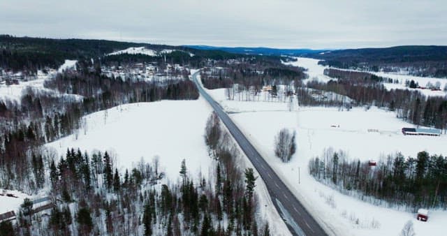 Snow-covered landscape with winding road