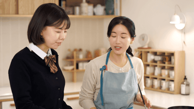 Mother and daughter preparing meal together in kitchen