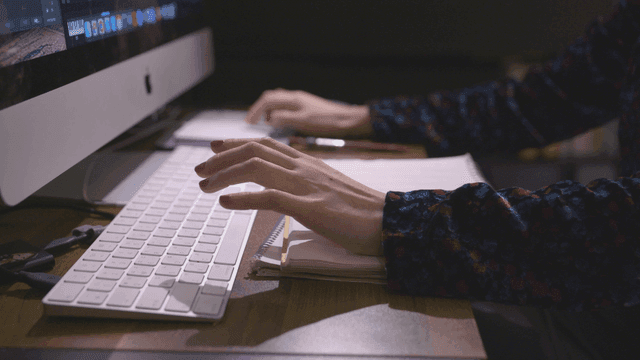 Hands operating keyboard and touchpad