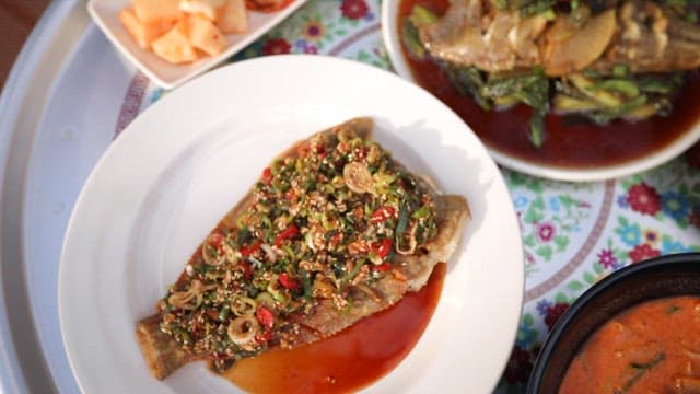 Korean-style meal table with various dishes made with flounder