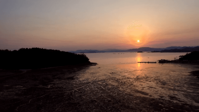 Sunset over a tranquil coastal landscape