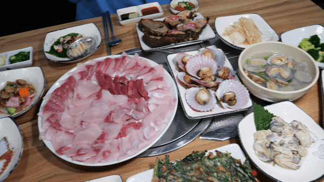 Sashimi and seafood filling sushi restaurant table