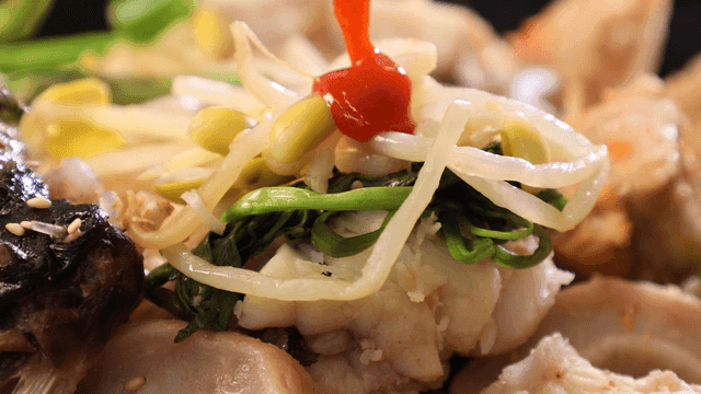 Boiled anglerfish topped with water celery, bean sprouts, and chili sauce