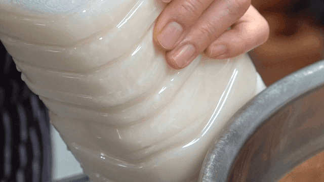 White soy milk poured into a plastic bottle