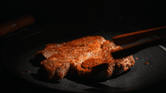 Steak being cooked on a pan