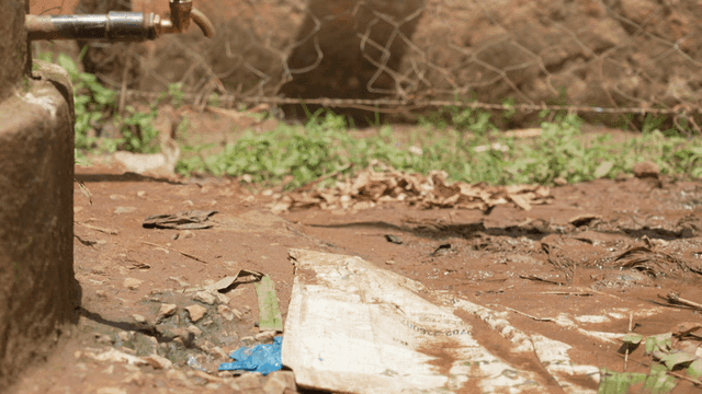 Outdoor scene with a water tap and mud