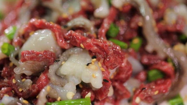 Fresh sliced octopus and beef tartare with green pepper