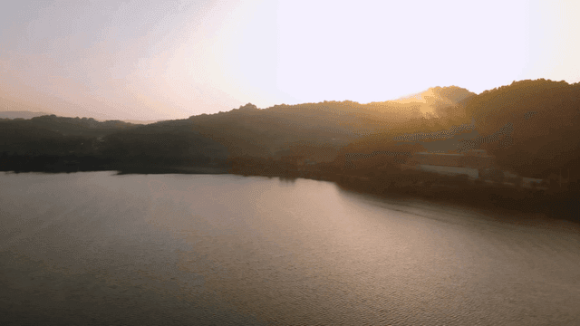 Tranquil lake and mountains at sunrise