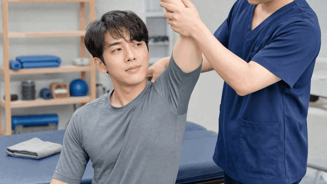 Man receiving shoulder rehabilitation treatment
