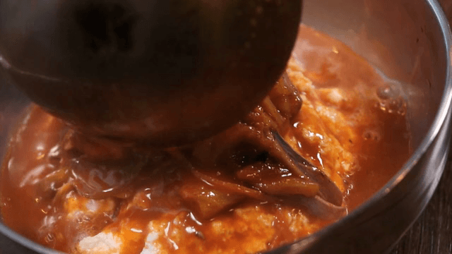 Spicy seafood soup with soft bean curd on the table