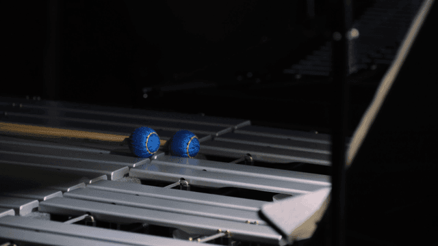 Blue mallets resting on a xylophone