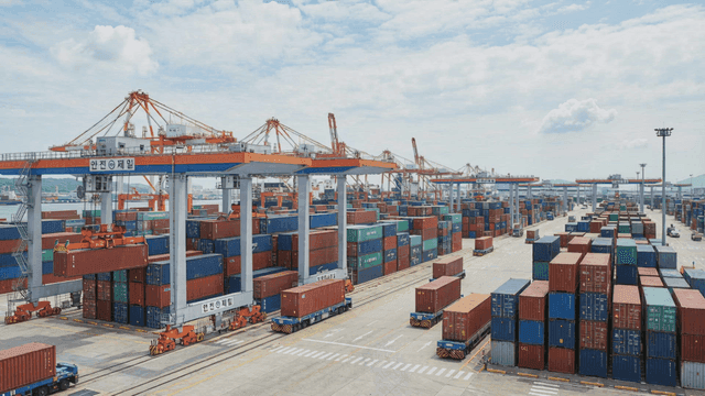 Busy container port with cranes and trucks