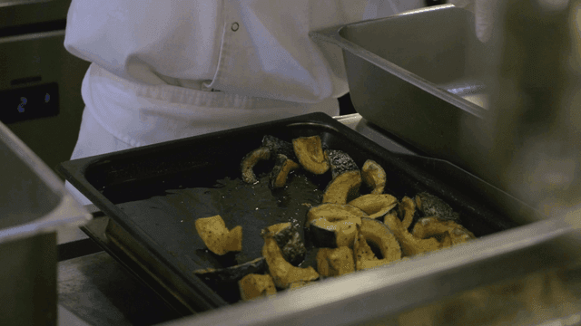 Chef preparing roasted pumpkin slices