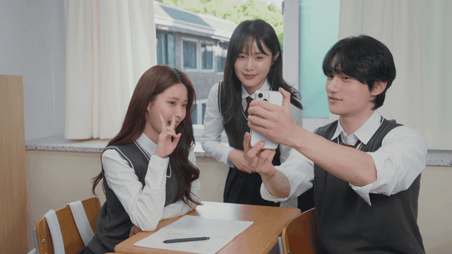 Students taking a selfie in a classroom