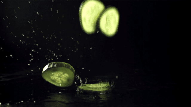 물과 함께 떨어지는 오이 슬라이스 조각들