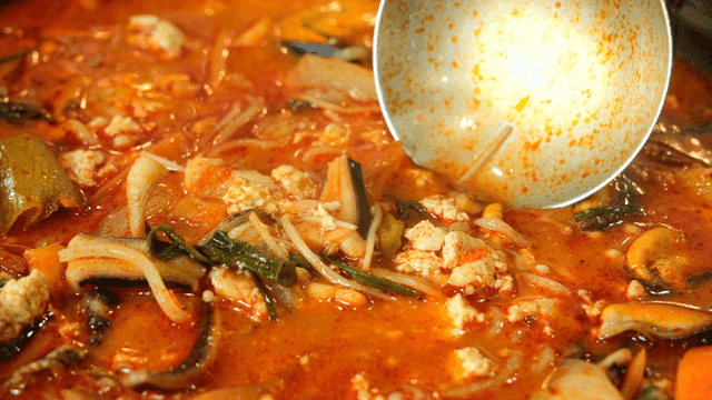 Seafood stew boiling in pot