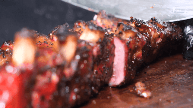 Juicy Texas barbecue slicing on cutting board