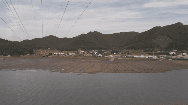 Coastal village with mountain backdrop
