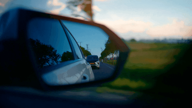 Cars and motorcycles visible in side mirrors