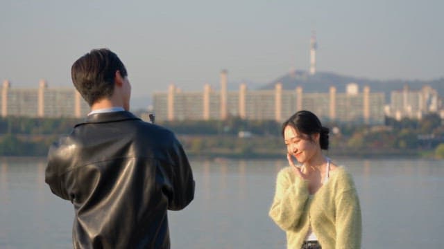 Woman posing for a photo by the river