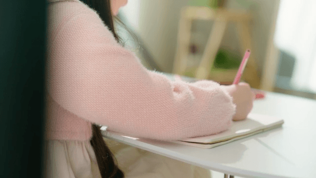 Young girl drawing with colored pencils
