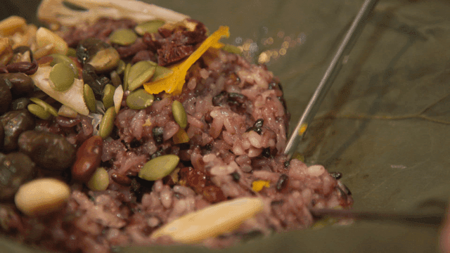 Chopsticks for tearing lotus leaf mixed grain rice containing nuts and seeds