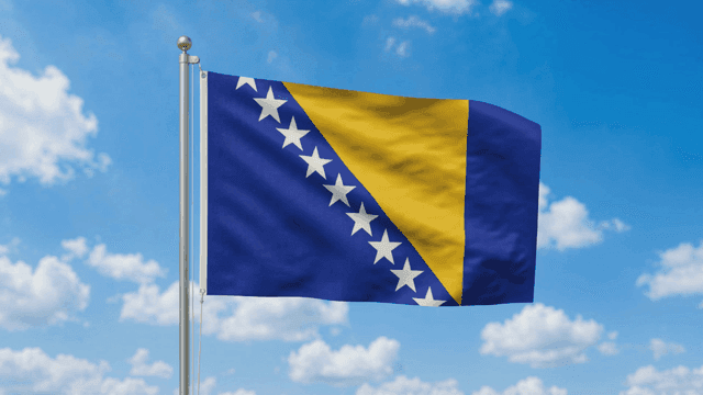 Flag of Bosnia and Herzegovina against blue sky