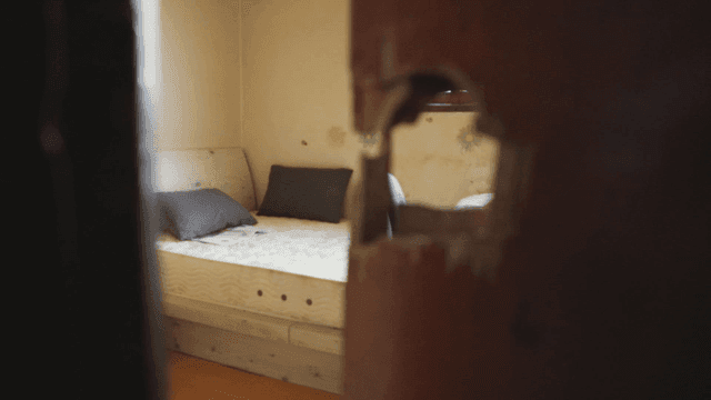 Room with a broken door and bed