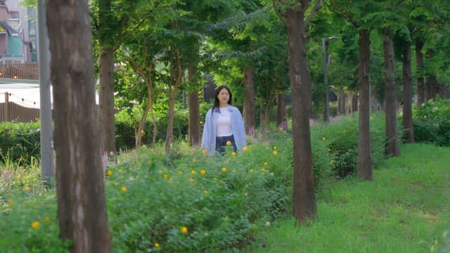 Woman walking through a green park