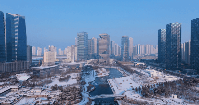 Snow-covered cityscape with modern buildings