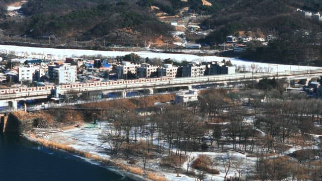 Winter Train Passing Through Snowy Town Landscape