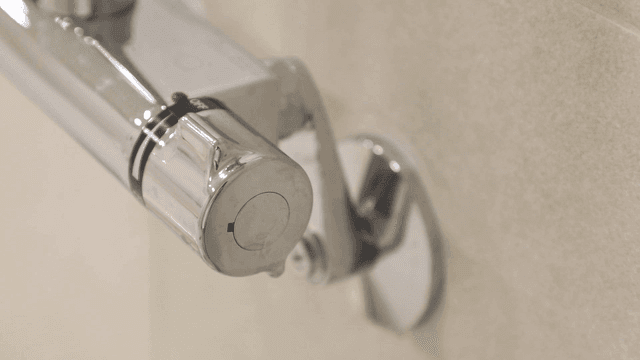 Close-up of a shower faucet handle