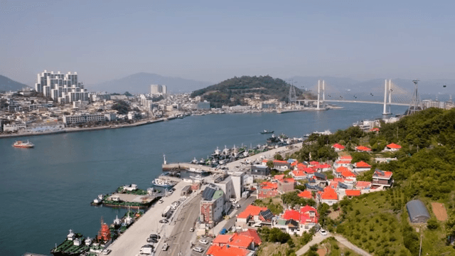 Coastal city with a bridge and colorful rooftops