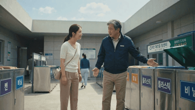 Security guard and woman talking at recycling sorting area