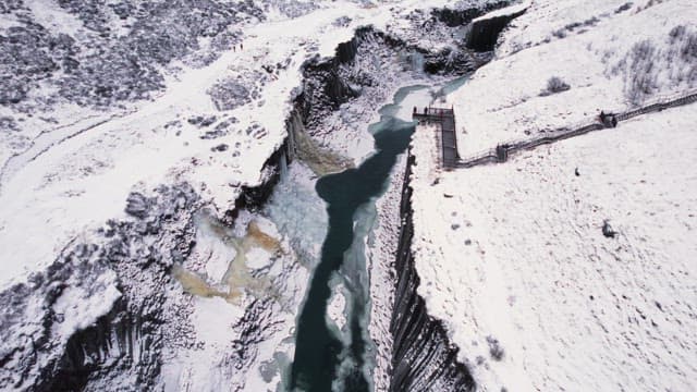 Snow-covered canyon with a frozen river