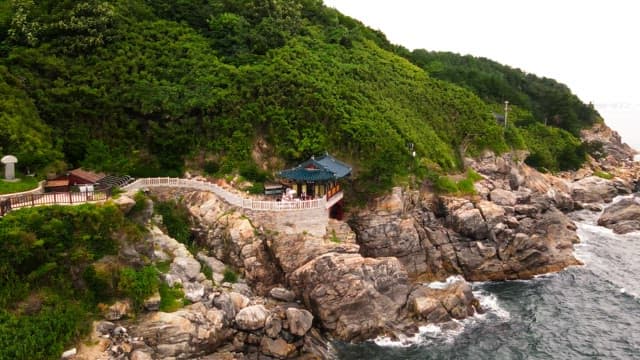 Traditional Korean temple on a coastal cliff