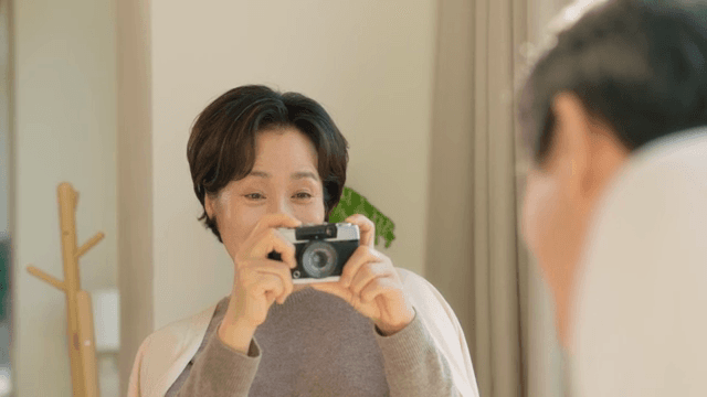 Woman smiling while holding a camera