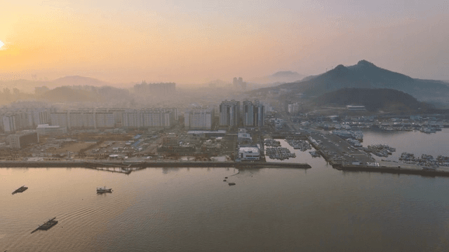 Cityscape with a serene sunset over the water