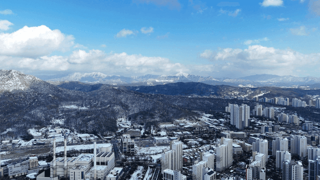 Snow-covered cityscape with mountains