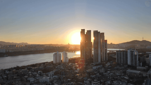 Sunset over a city skyline with river
