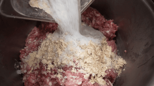 Spices poured onto minced meat