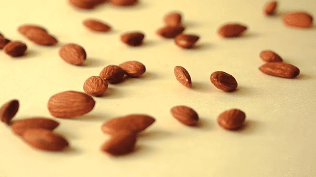 노란색 바닥에 떨러지는 아몬드