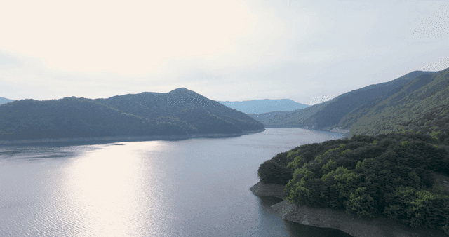 A tranquil lake surrounded by lush mountains
