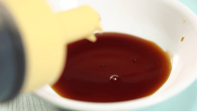 Soy sauce poured into white soy sauce dish