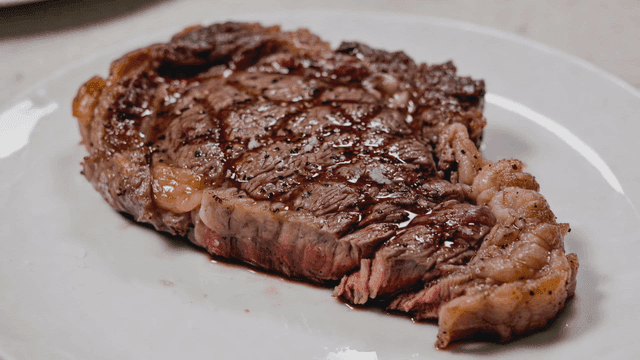 Juicy grilled steak on a white plate
